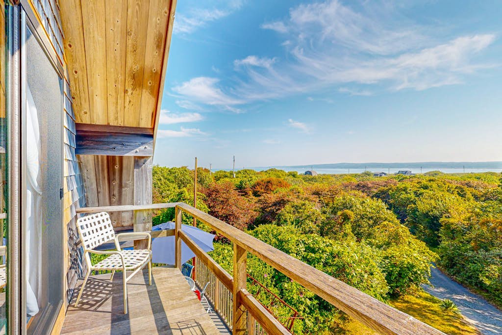 Water-view home with large deck, balcony, enclosed sunroom & peaceful location