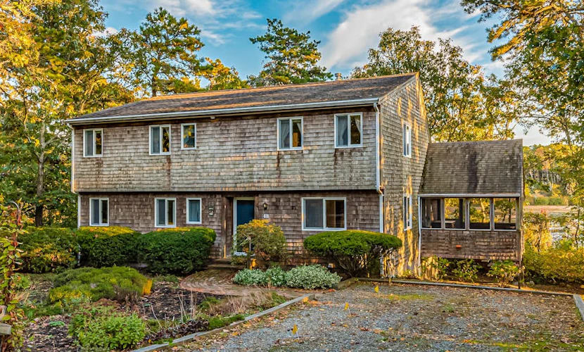 Waterfront home with lovely lake views, great deck, sun porch & fireplace