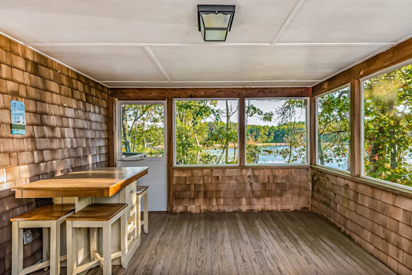 Waterfront home with lovely lake views, great deck, sun porch & fireplace