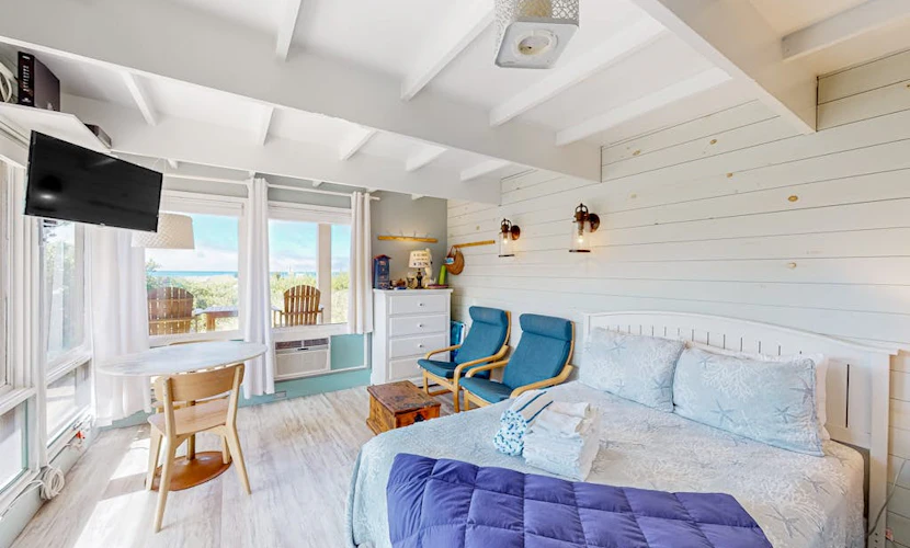 Charming coastal studio with private beach access, scenic patio, grill, & games