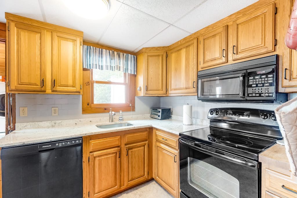 Two-story home with beach access, sunroom, fast WiFi, washer/dryer, & partial AC