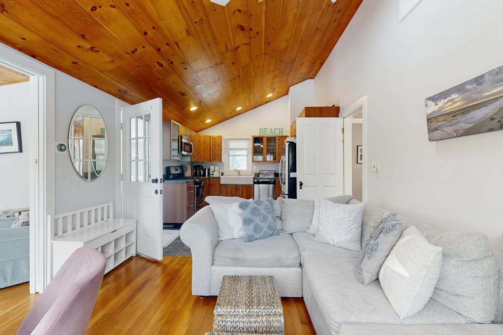 Stylish island retreat with sunny interiors, wraparound deck, firepit & AC