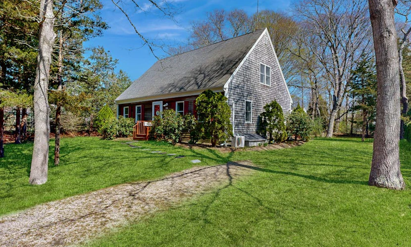 2-story home near the beach with large lawn, deck, W/D, streaming, & partial AC