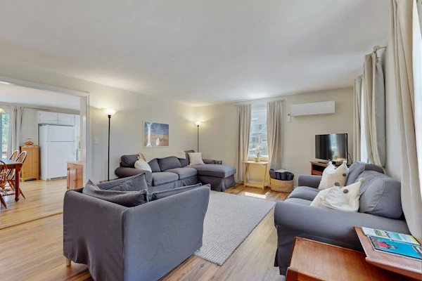 2-story home near the beach with large lawn, deck, W/D, streaming, & partial AC