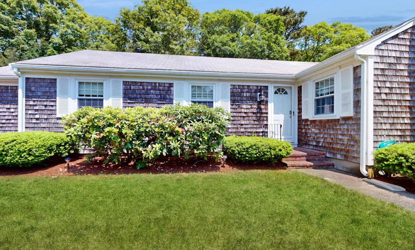 Charming coastal home near pond with sunroom, open layout, yard & AC