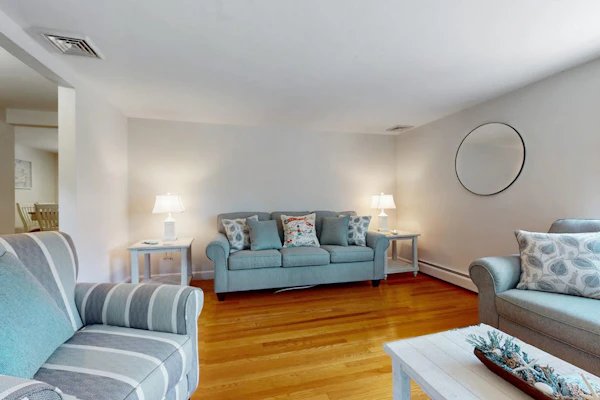Charming coastal home near pond with sunroom, open layout, yard & AC