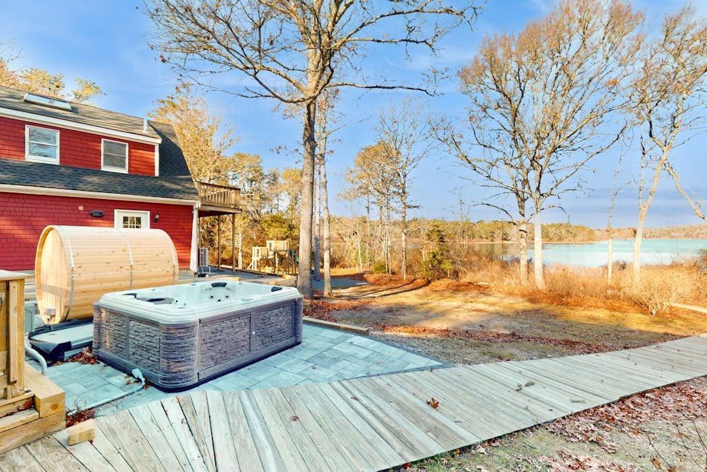 Pondfront escape with private beach, hot tub, sauna, play area & dog-friendly