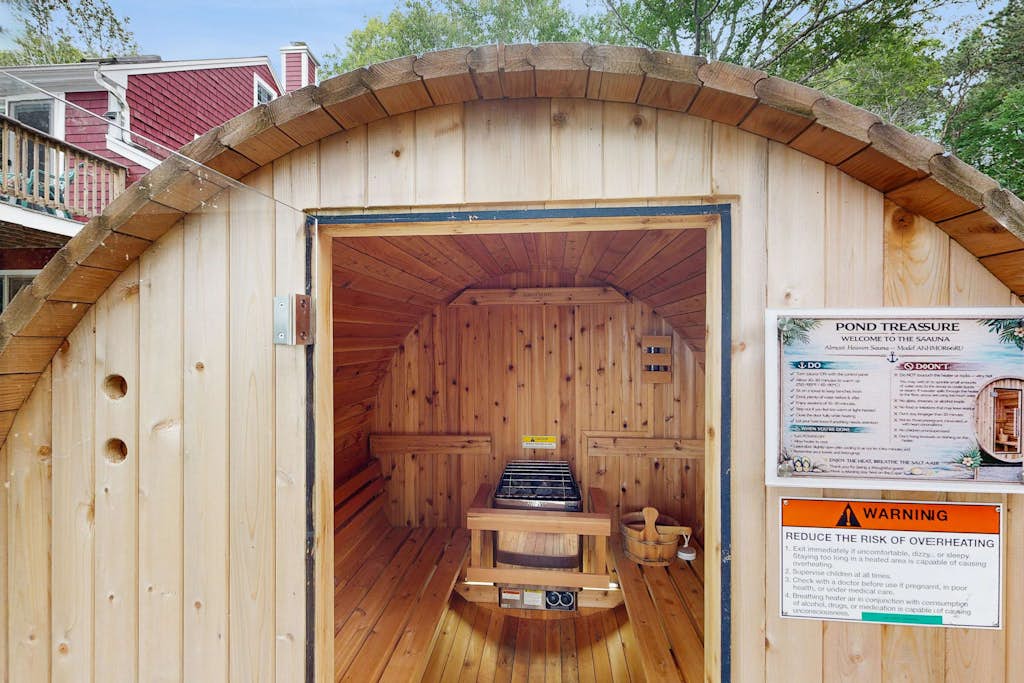 Pondfront escape with private beach, hot tub, sauna, play area & dog-friendly