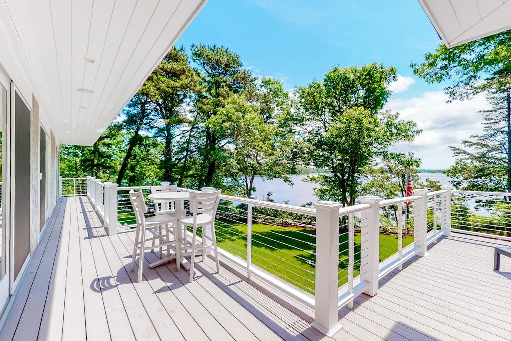 Luxe lakefront home on Follins Pond with private beach, amazing decks & yard