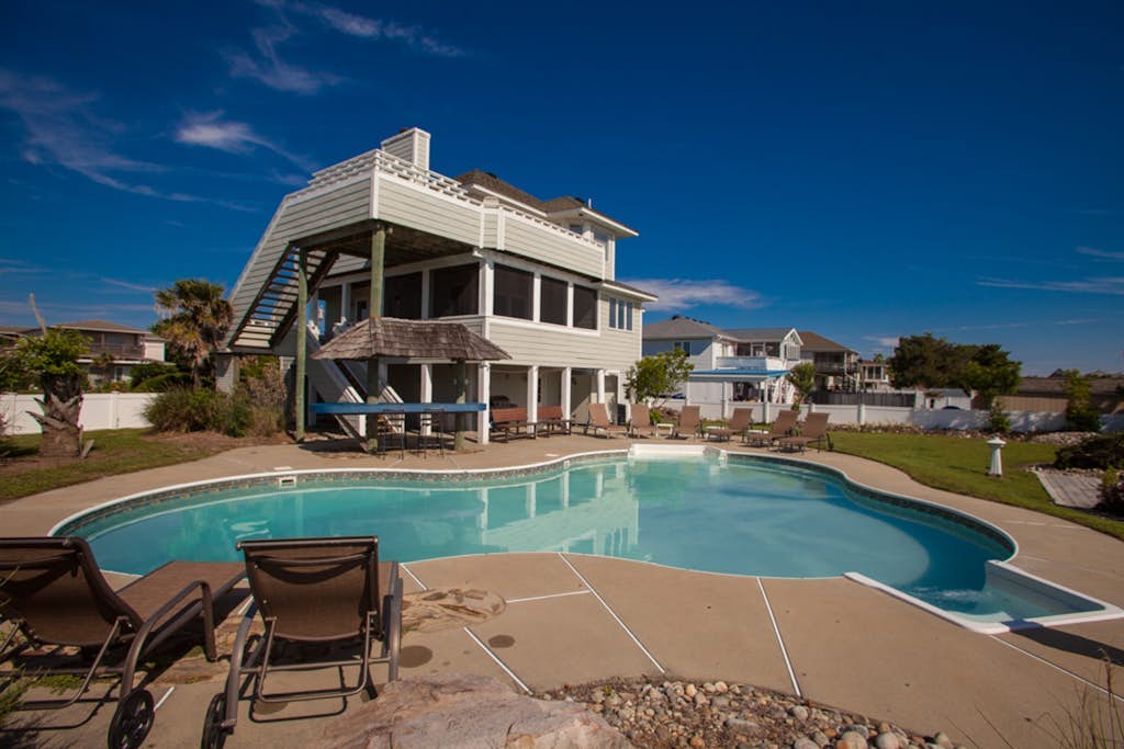 Revival-style canalfront home with private pool, two docks, beach access & views