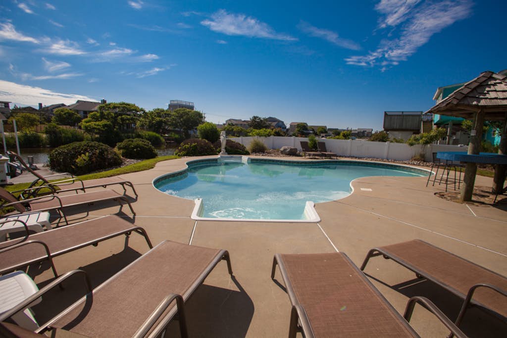 Revival-style canalfront home with private pool, two docks, beach access & views