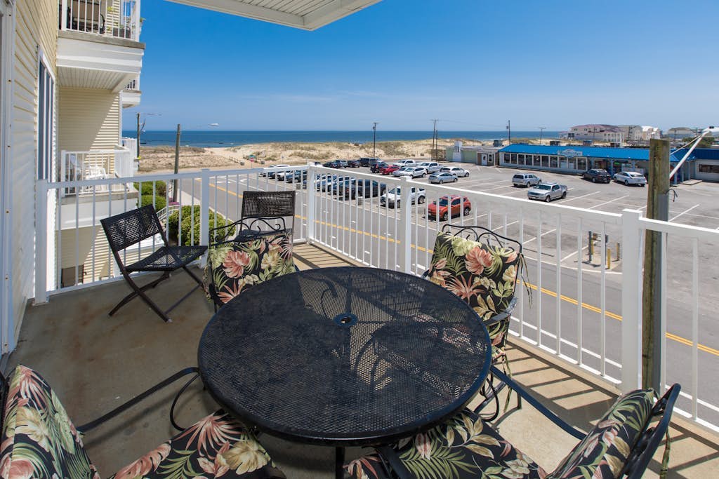 Second-floor, ocean view condo with balcony, foosball, WiFi & on-site pool/gym