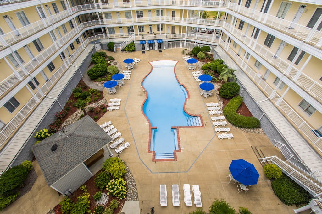 Second-floor, ocean view condo with balcony, foosball, WiFi & on-site pool/gym