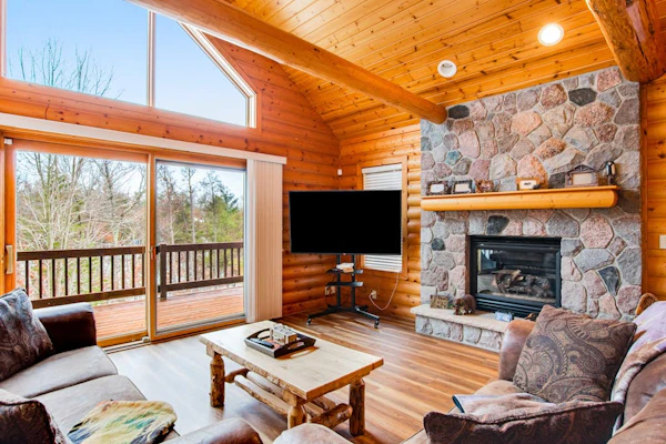 Secluded, dog-friendly home with tree-lined view, firepit, fireplace, & deck