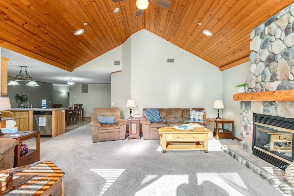 Riverfront golf resort condo with pool, hot tub, volleyball, & fairway-view deck