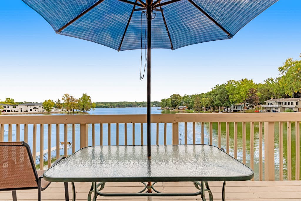 Lakefront dog-friendly condo near skiing with private beach access, views & dock