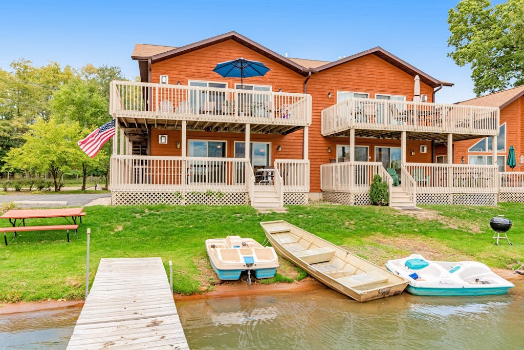 Lakefront dog-friendly condo near skiing with private beach access, views & dock