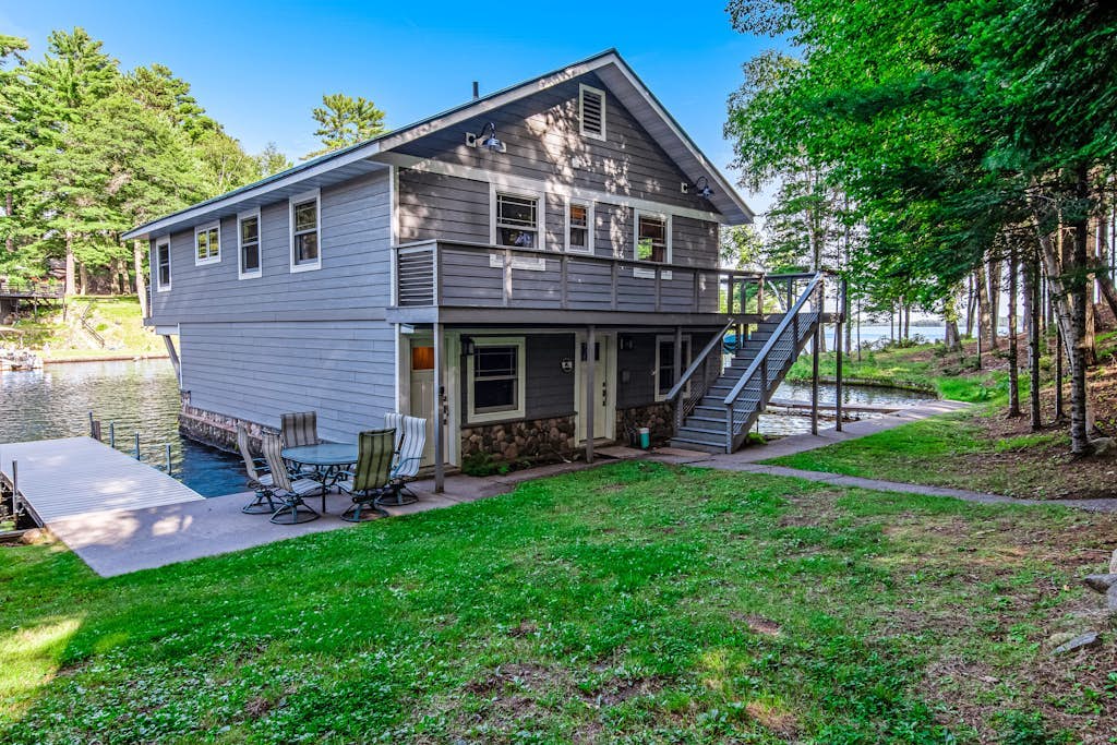 Dog-friendly, lakefront getaway w/ a wraparound balcony, beach, & boat access