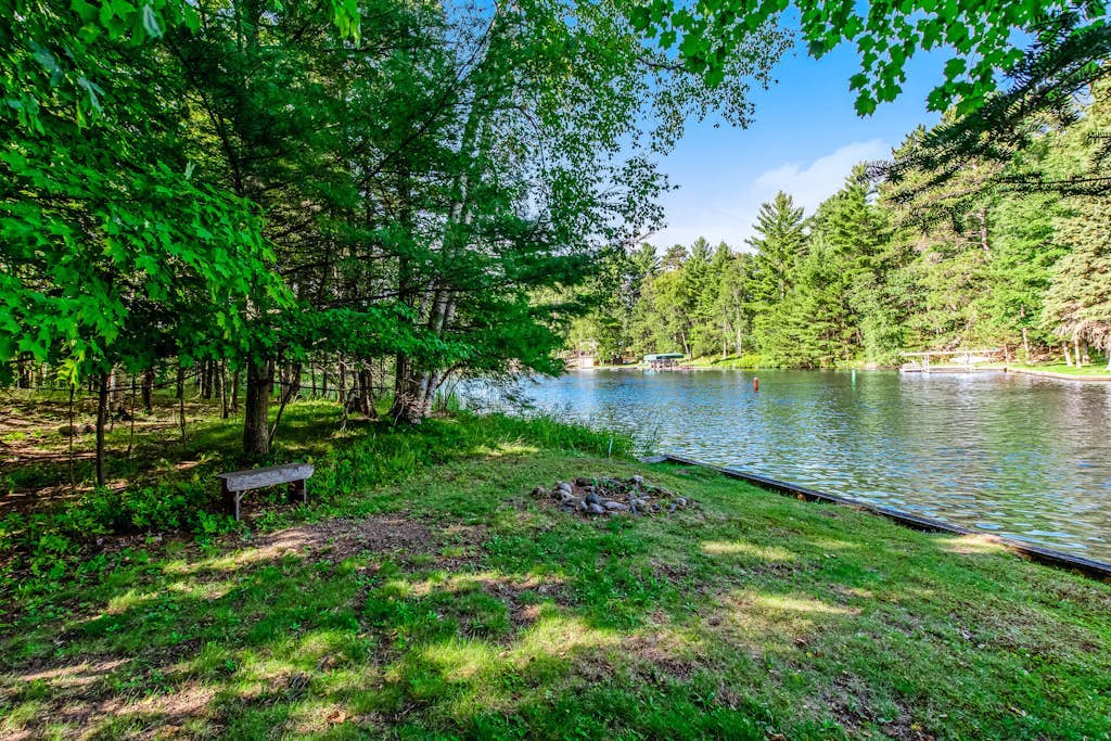 Dog-friendly, lakefront getaway w/ a wraparound balcony, beach, & boat access