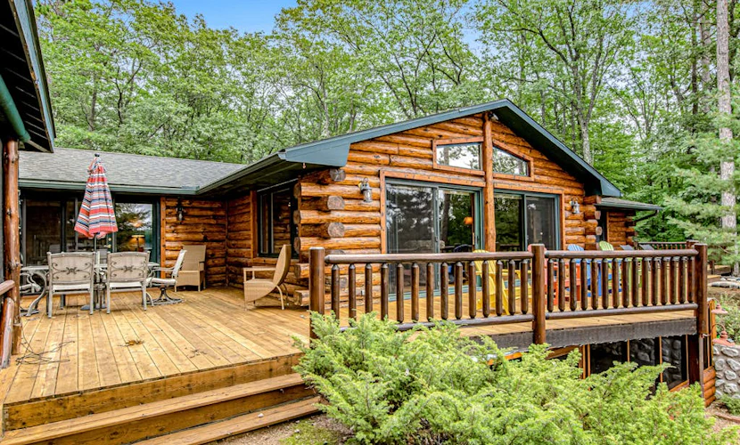 Lakefront log cabin on 3.5 acres with dock, gazebo & sunset views - dog-friendly