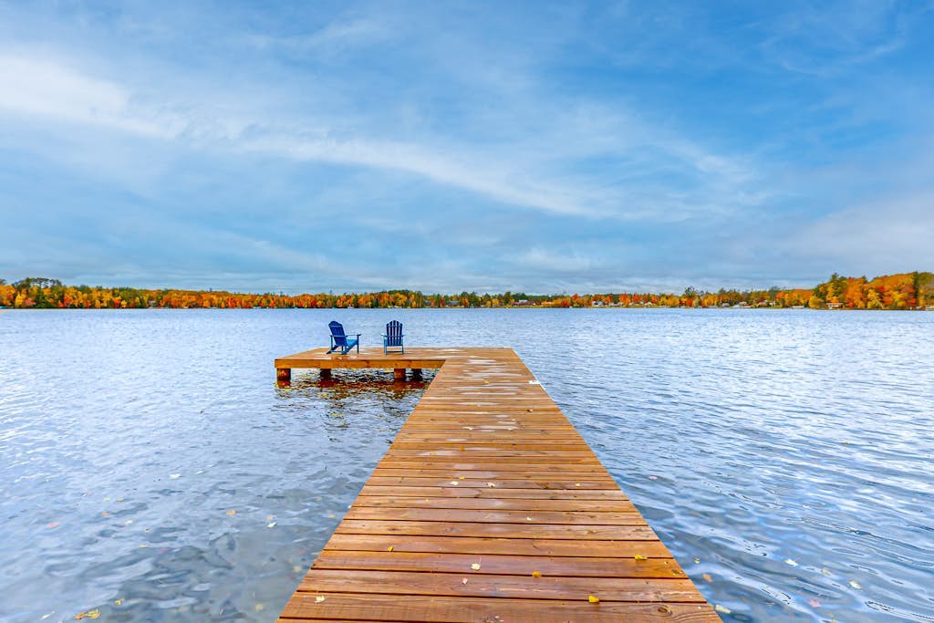 Lakefront home with yard, private dock, deck, firepit, & washer/dryer