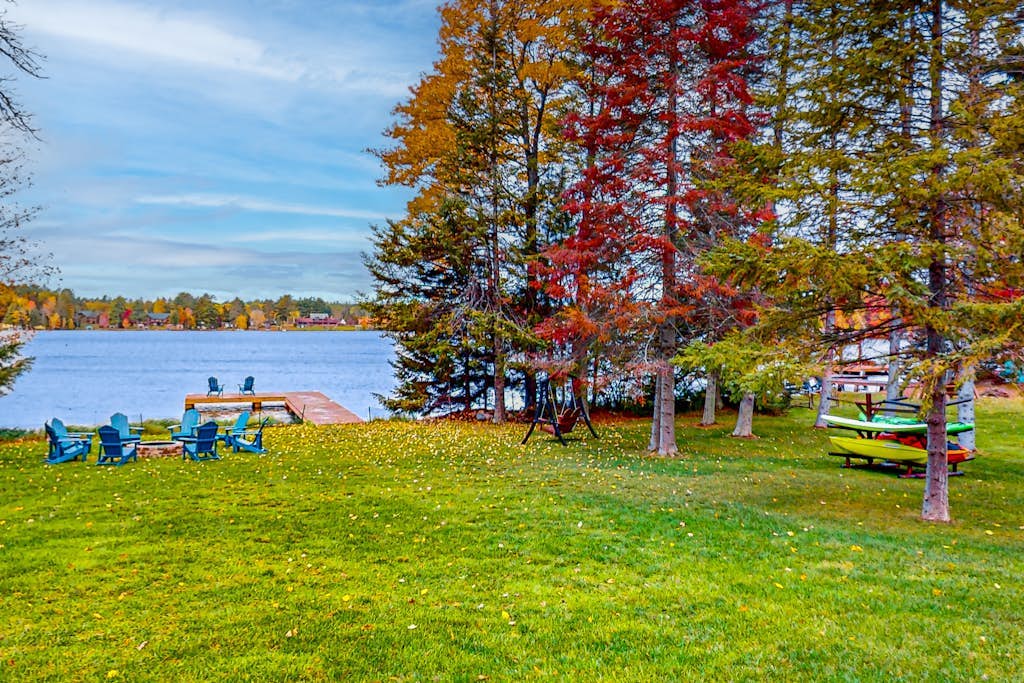 Lakefront home with yard, private dock, deck, firepit, & washer/dryer