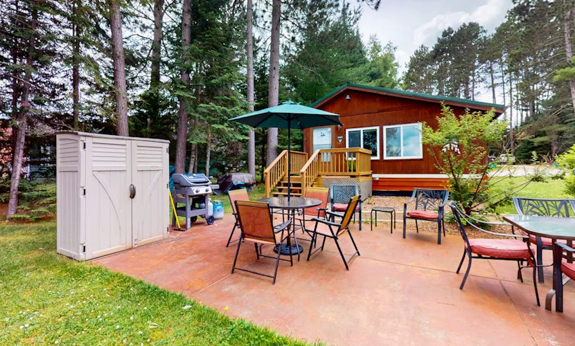 Lakefront cottage w/ a dock, shared furnished patio, firepit, & a paddleboat