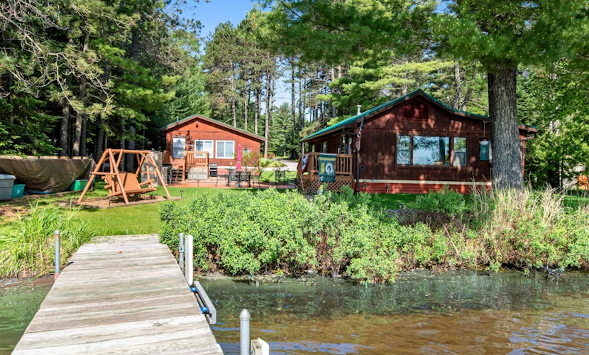 Two cozy, lakefront cottages w/ 2 docks, a patio, firepit, 2 gas grills, & WIFI