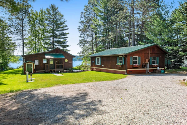 Two cozy, lakefront cottages w/ 2 docks, a patio, firepit, 2 gas grills, & WIFI