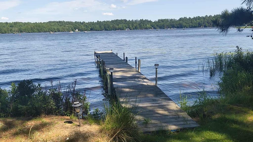 Two cozy, lakefront cottages w/ 2 docks, a patio, firepit, 2 gas grills, & WIFI