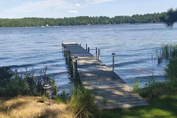 Two cozy, lakefront cottages w/ 2 docks, a patio, firepit, 2 gas grills, & WIFI