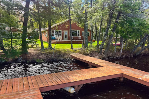 Dog-friendly lakefront property with dock, boat lift, firepit, & hot tub