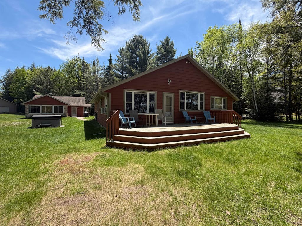 Dog-friendly lakefront property with dock, boat lift, firepit, & hot tub