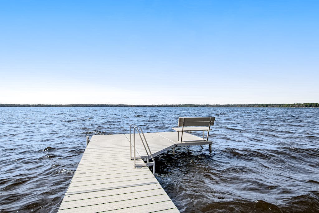 Dog-friendly, lakefront house with beach access, dock, AC, W/D, patio, & firepit