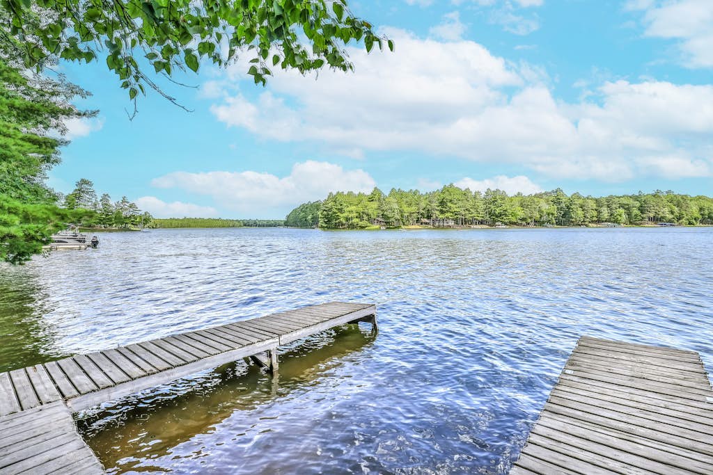 Renovated lake-view retreat with full rec lake access, boat slips, & firepits
