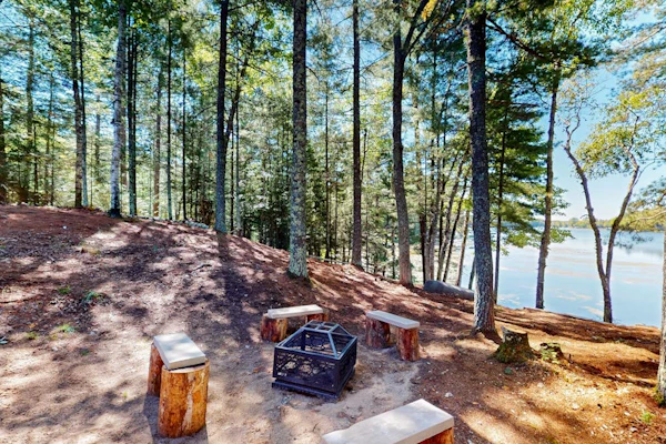 Dog-friendly, lakefront getaway with a firepit, dock, washer/dryer, & AC