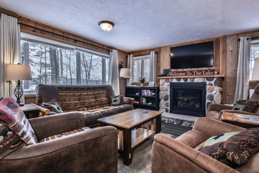 Snowy lake-view cabin with fireplace, full kitchen, TV, dock, & DVD player