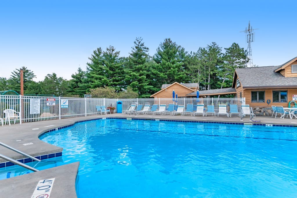 Golf course-front condo with pool, hot tub, dock, tennis, golf, & private beach