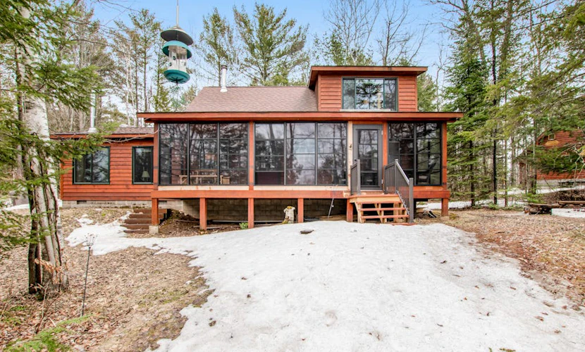 Riverfront vacation home with a dock, wood stove, full kitchen, & firepit