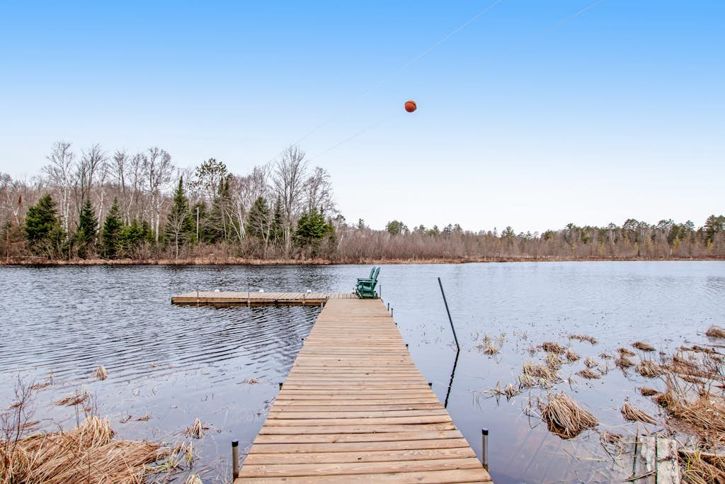 Riverfront vacation home with a dock, wood stove, full kitchen, & firepit