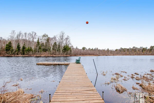 Riverfront vacation home with a dock, wood stove, full kitchen, & firepit