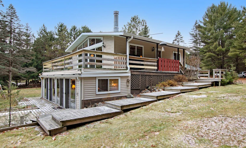 Lakefront Home with a Private Dock, Deck, Fireplace, Spacious Yard, & Playset