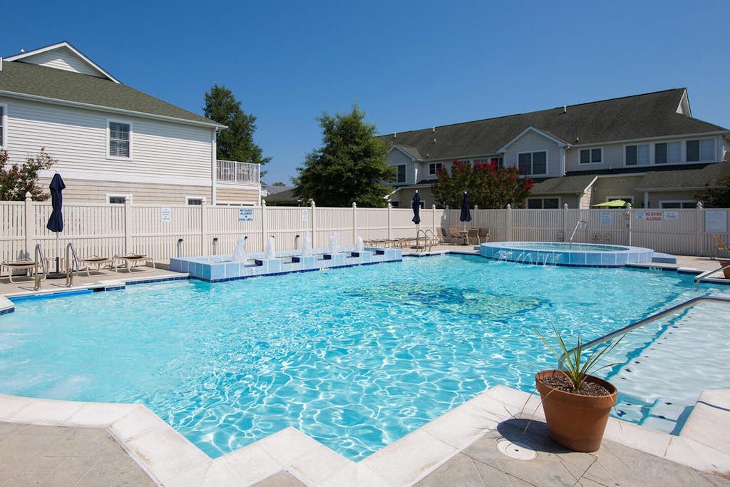 The Tides townhome with pond-front balcony, screened patio, & pool