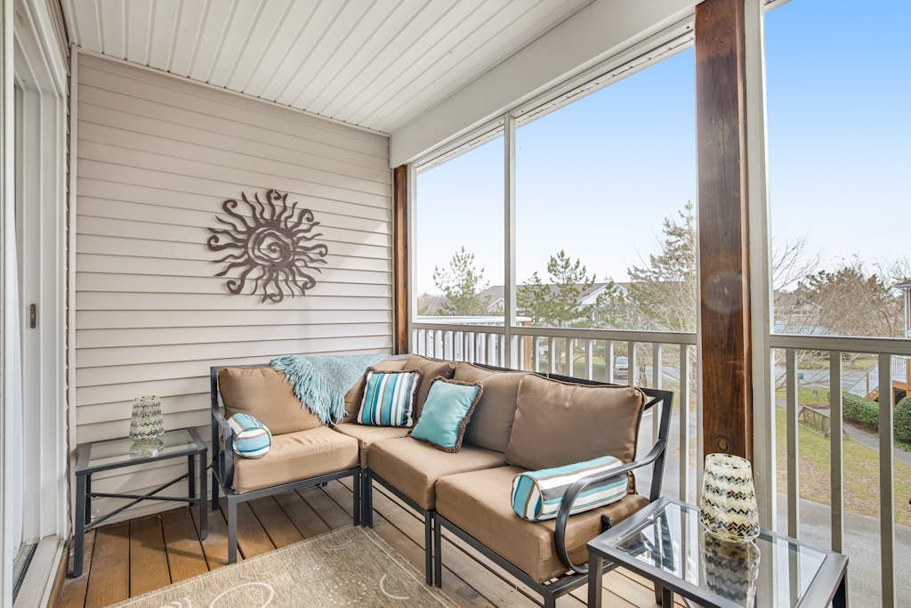 Two-story beach gem with wraparound screened porch, pool, sauna & gym