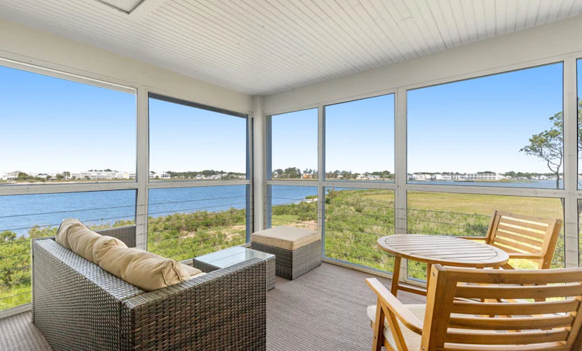 Bay view condo with screened porch, central AC, on-site golf and shared pool