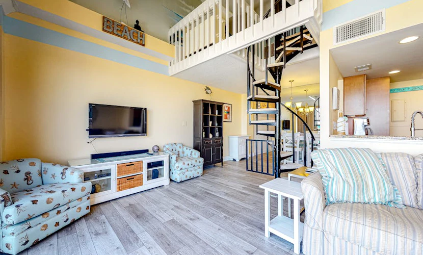 Fun lofted escape near the beach with private balcony, ocean views, WiFi & AC