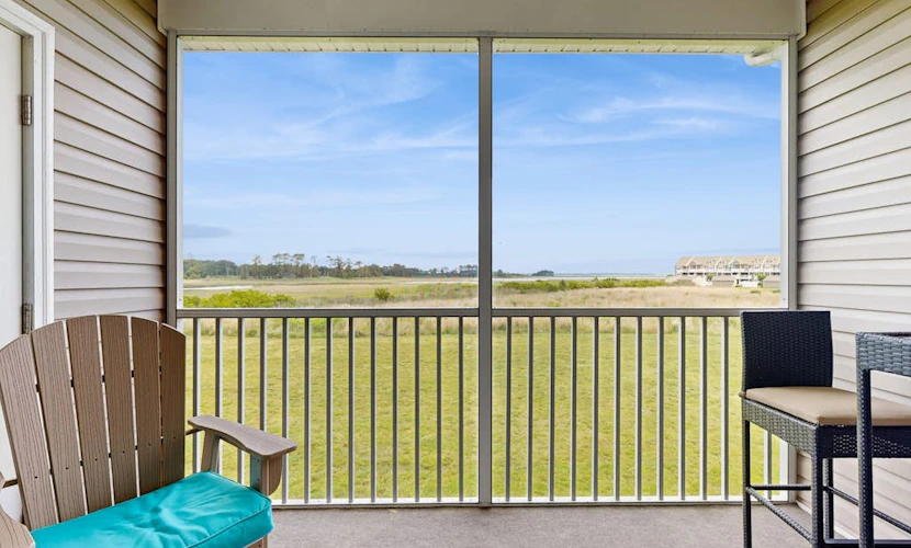 Bethany Bay condo with bay views, athletic courts, pool, fireplace, & balcony