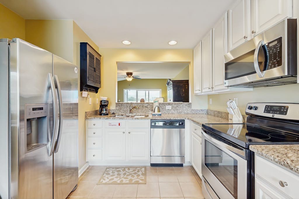 Bethany Bay condo with bay views, athletic courts, pool, fireplace, & balcony