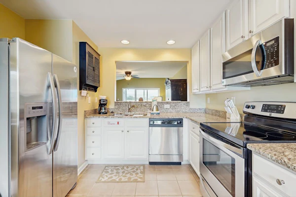 Bethany Bay condo with bay views, athletic courts, pool, fireplace, & balcony