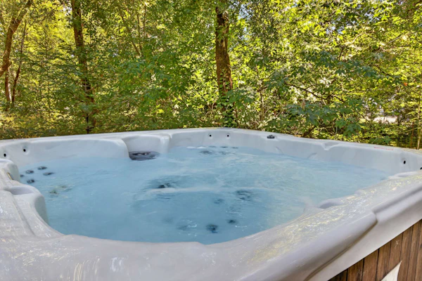 Slip into the hot tub as dusk settles over your private forest sanctuary. This contemporary 3-bedroom retreat sleeps 6 in serene seclusion, with floor-to-ceiling windows framing mature oaks from every room. You're just 0.9 miles from Glen Ellen Star's wood-fired cuisine and Jack London State Historic Park's redwood trails. The deck wraps around towering trees — morning coffee here feels like a meditation.